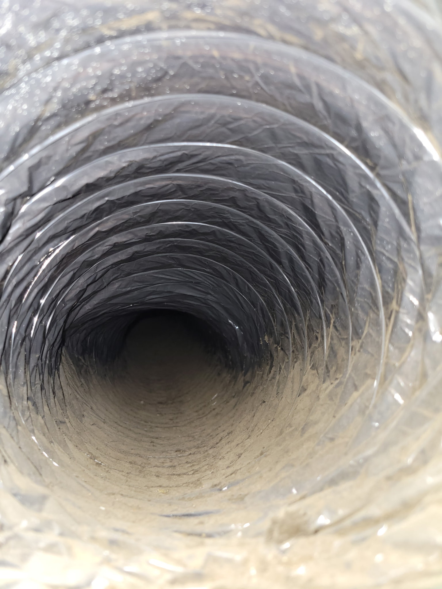 Round duct interior with visible buildup.