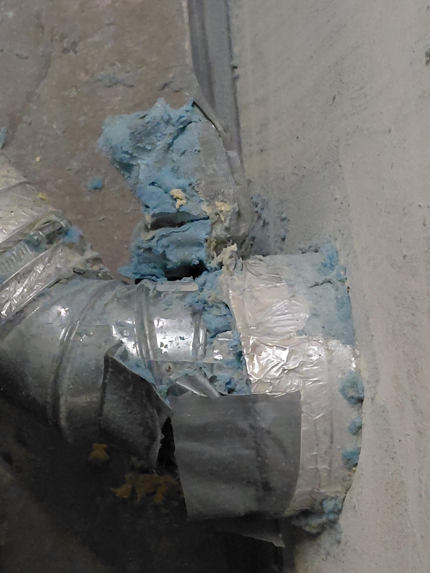 Loose insulation and material documented near ductwork.