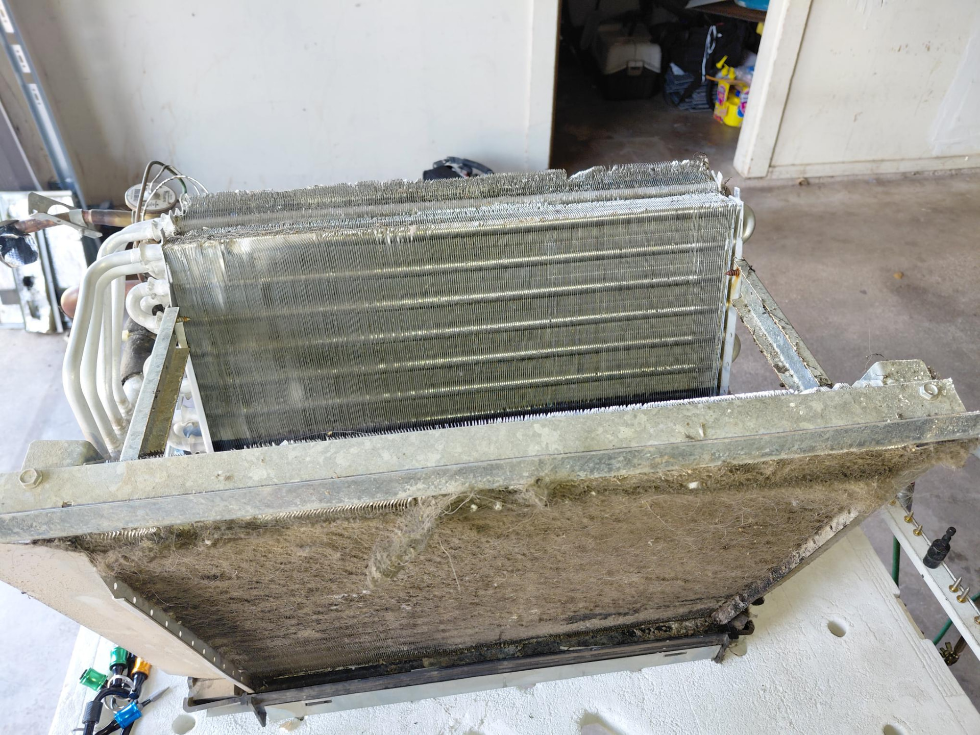 Removed HVAC coil with visible accumulated debris.
