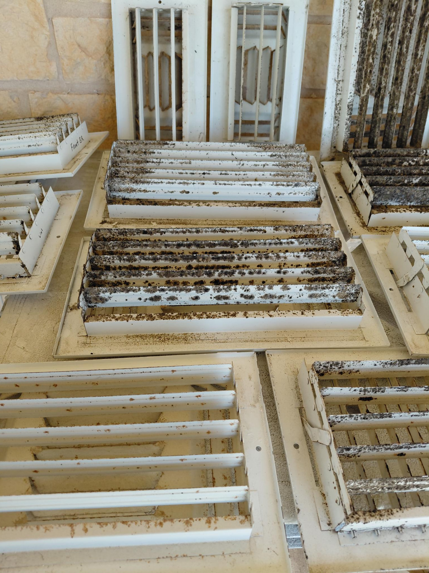 Vent grilles with visible accumulated buildup.
