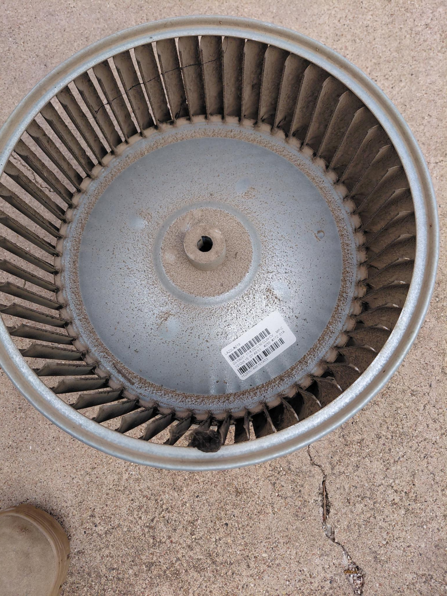 Blower wheel with visible accumulated buildup.